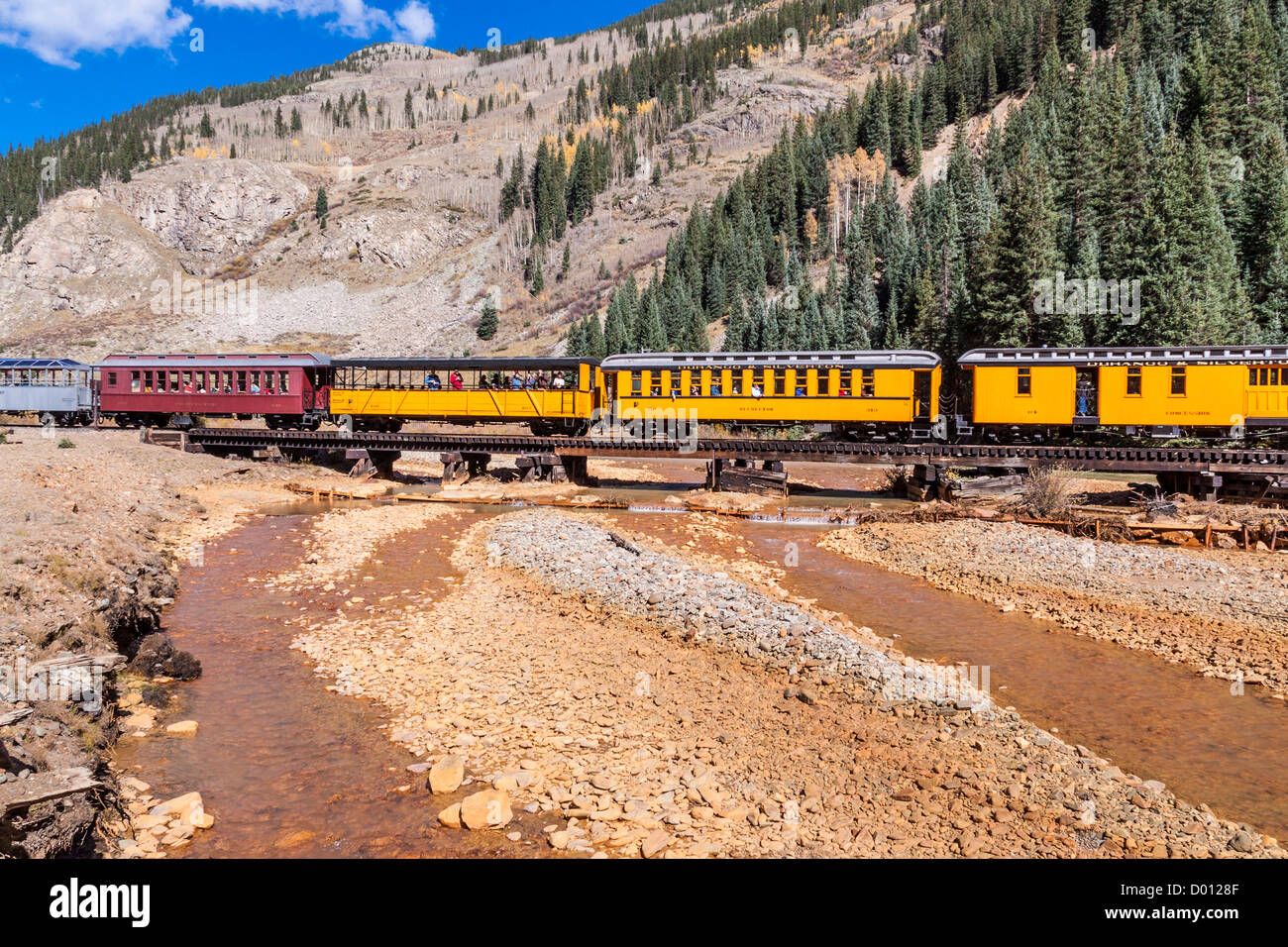 1925 Baldwin Steam Locomotive, 2-8-2 configuration, Mikado type, with antique, classic railcars, at the Animas River Bridge near Silverton, Colorado. Stock Photo