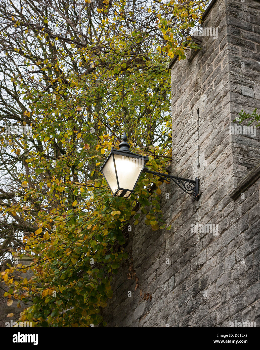 Glowing street lamp on a castle wall Stock Photo - Alamy