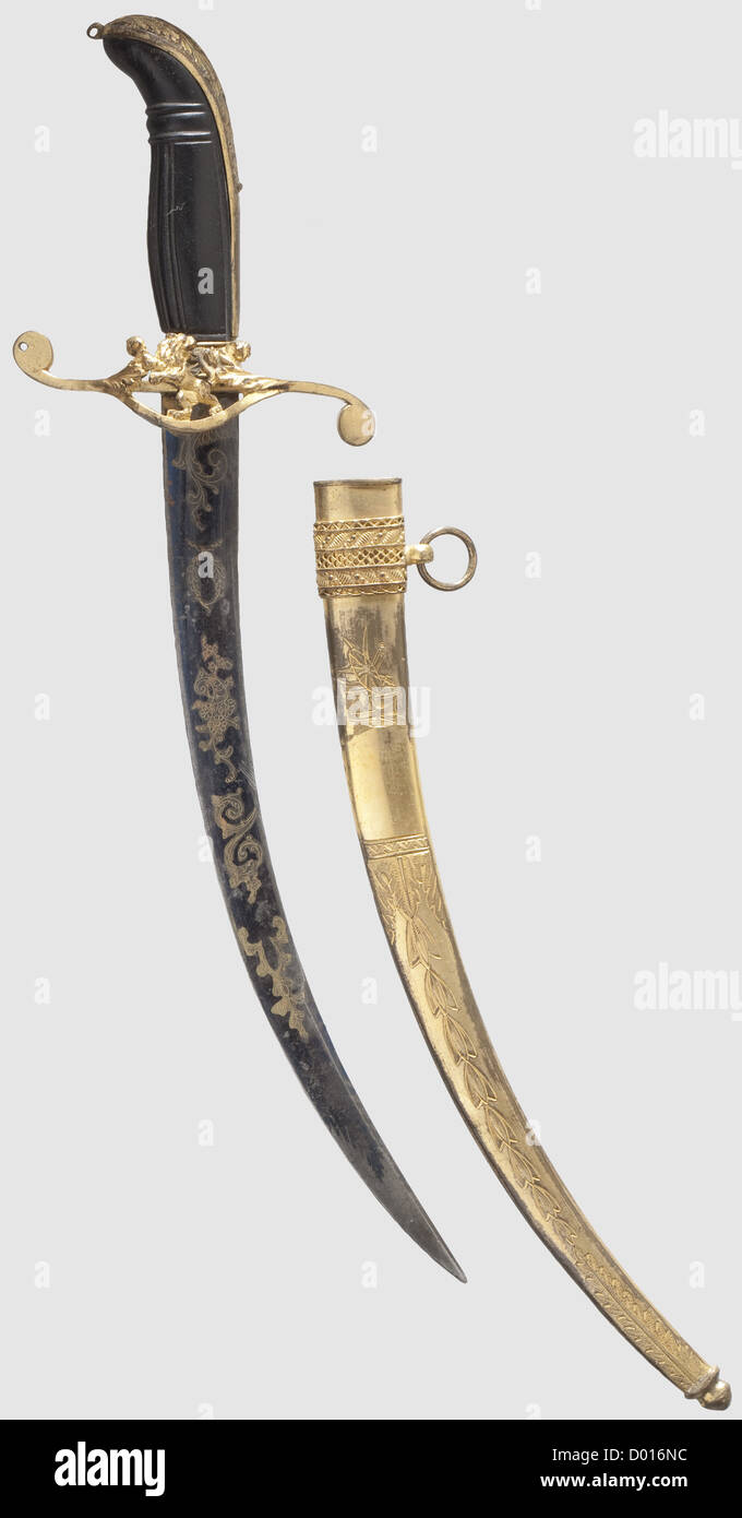 A naval dagger,probably England,circa 1810. Curved single-edged blade with a double-edged tip,both sides with a gilt floral etching against a blued background. Gilt brass hilt,perforate crossguard(bent,sprung)showing a rampant lion. Lightly carved ebony wood grip. Chain missing. Gilt brass scabbard with engraved martial trophies and floral décor. Length 32 cm,historic,historical,19th century,thrusting,thrustings,blade,blades,melee weapon,melee weapons,hand weapon,hand weapons,handheld,weapon,arms,weapons,arms,object,objects,stills,cli,Additional-Rights-Clearences-Not Available Stock Photo
