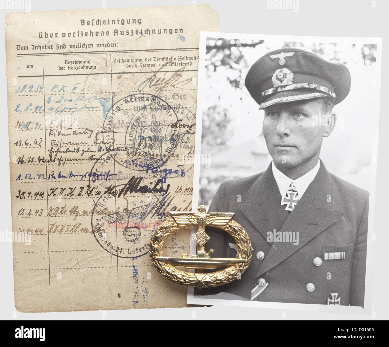 Karl-Friedrich Merten - a U-Boat War Badge with Diamonds and a page from his pay book with a record of earned awards, Silver, gilt with polished edges, applied swastika with nine rose-cut diamonds, bellied pin on a flat hinge, maker 'Schwerin Berlin 68'. Characteristical Schwerin version with excellent finish. Signs of wear. 48.5 x 38.8 mm. Weight 31.35 g. The page from the pay book with confirmations of received awards, including the Knight's Cross on 13 Juni 1942, the Oak Leaves on 16 November 1942 and the U-Boat War Badge with Diamonds on 12 February 1943. A, Stock Photo