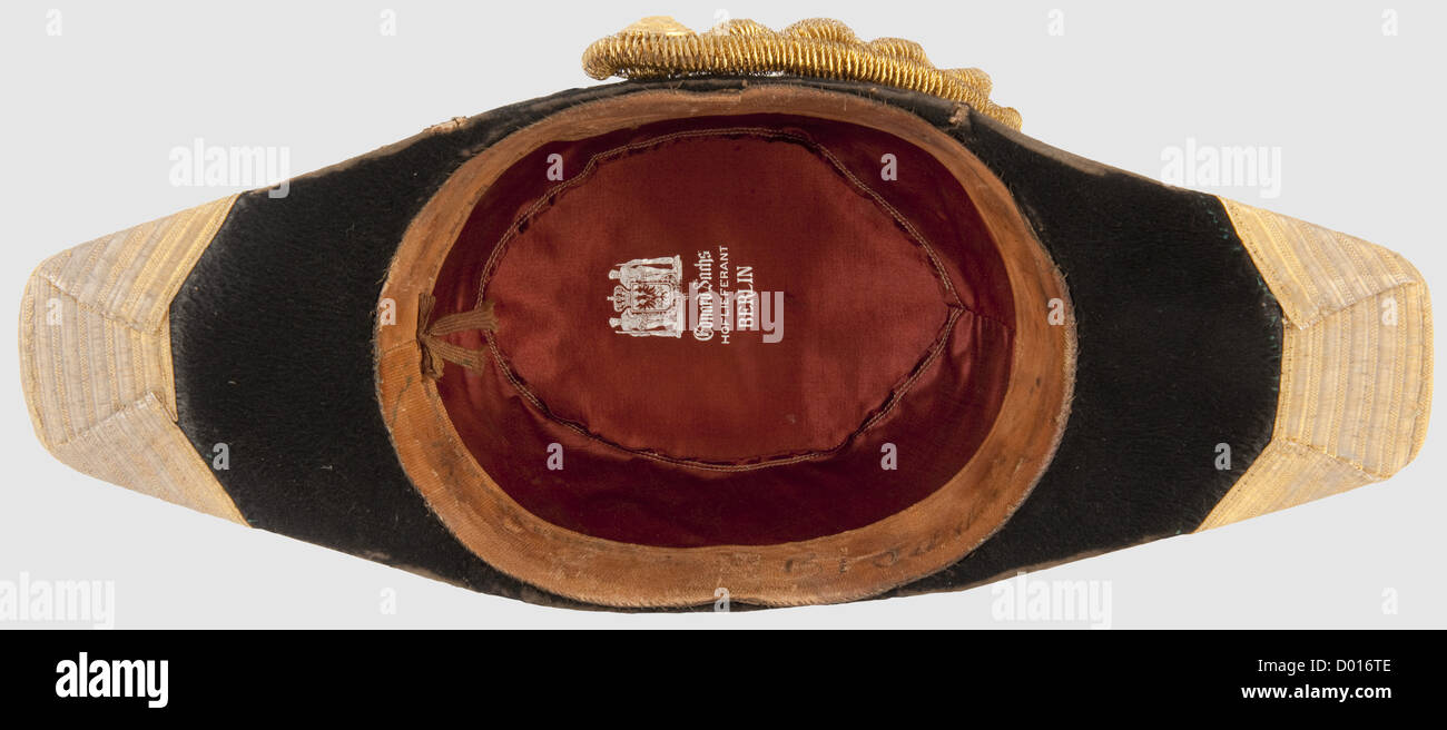 An Admiral's bicorn,Black mohair felt trimmed with broad,golden lace. Gold button and bullion loop above a silk cockade. Dark red silk lining and light leather sweatband with an illegible inscription. Somewhat dented,slight marks of wear and age. In a protective case lined with yellow silk,repaired,with distinctive signs of age,historic,historical,1900s,1910s,20th century,navy,naval forces,military,militaria,branch of service,branches of service,armed forces,armed service,object,objects,stills,clipping,clippings,cut out,cut-out,cut-out,Additional-Rights-Clearences-Not Available Stock Photo