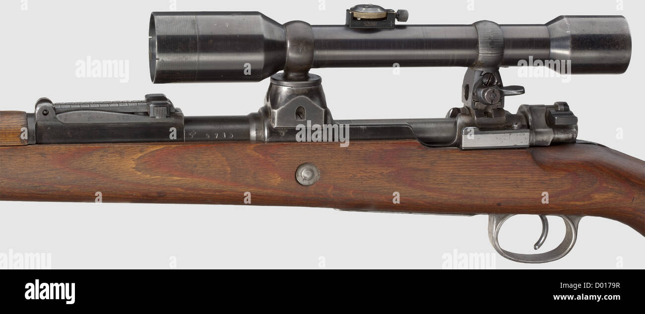 A scope rifle 98 k,Mauser,with high top-hinged mount and scope ZF Ajack,cal. 8 x 57,no. 5713. Matching numbers. Almost bright bore. Receiver head covered by front mount socket,but various acceptance marks eagle/"135" and barrel root marked "44D" which means produced at Mauser's,Oberndorf,at the end of 1944,beginning of 1945. Thin,spotted finish. Chamber thinly grey phosphatised,milled-off safety catch(replaced),matching-numbered firing pin,round gas release holes,without action spring guide. Sheet steel-stamped floorp historic,historical,1930s,,Additional-Rights-Clearences-Not Available Stock Photo