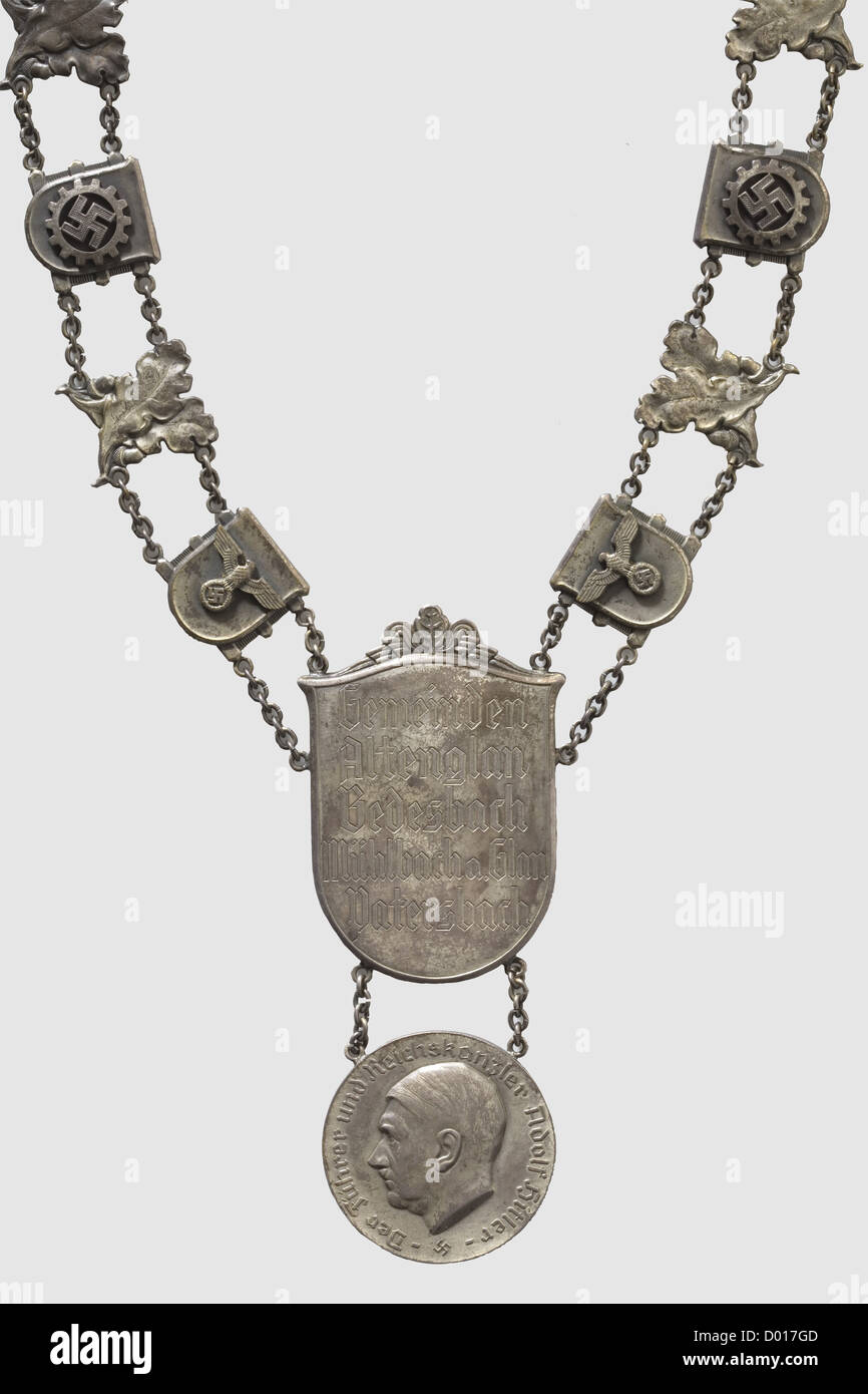 A Burgomaster's Chain for the municipalities of Alternglan,Bedesbach,Mühlbach on Glan and Patersbach,Silver medallion with portrait in relief and circumsription 'Der Führer und Reichskanzler Adolf Hitler'.Reverse with corresponding engraving and master's mark 'Mf'.Diameter 50 mm.Chain shield with the engraved names of the federated municipalities.Chain with alternating crossed oak leaves and coats of arms with applied national eagles,DAF- and 'Reichsnährstand' emblems.Weight ca.389 g.Included a later exhibition case,historic,historical,people,193,Additional-Rights-Clearences-Not Available Stock Photo