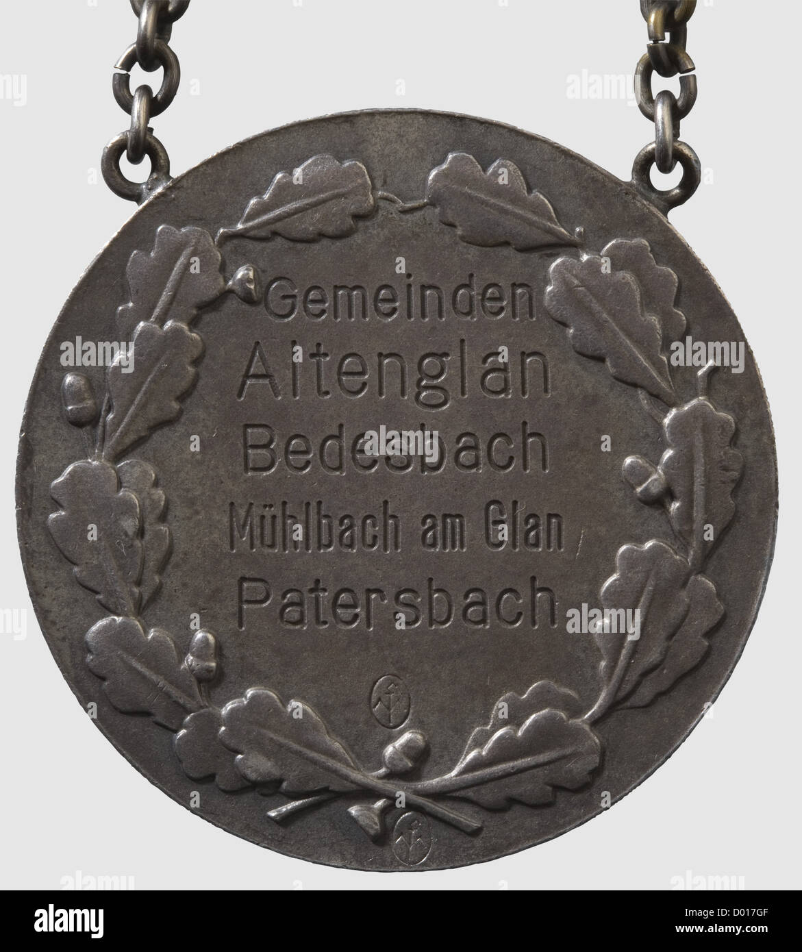A Burgomaster's Chain for the municipalities of Alternglan,Bedesbach,Mühlbach on Glan and Patersbach,Silver medallion with in relief and circumsription 'Der Führer und Reichskanzler Adolf Hitler'.Reverse with corresponding engraving and master's mark 'Mf'.Diameter 50 mm.Chain shield with the engraved names of the federated municipalities.Chain with alternating crossed oak leaves and coats of arms with applied national eagles,DAF- and 'Reichsnährstand' emblems.Weight ca.389 g.Included a later exhibition case,historic,historical,1930s,1930s,20th c,Additional-Rights-Clearences-Not Available Stock Photo