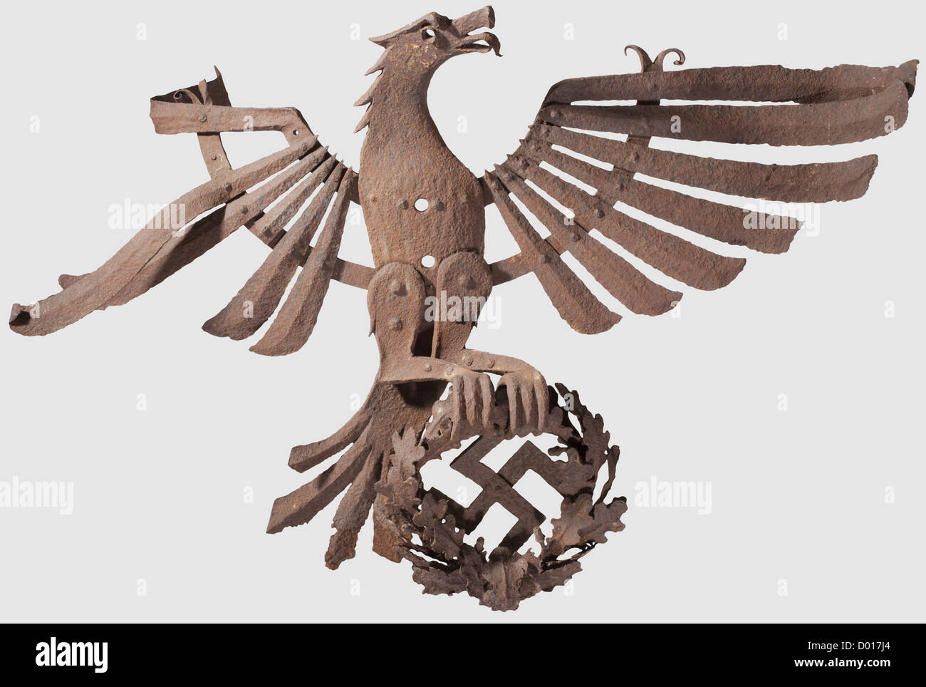 A large,wrought iron wall eagle,Assembled from several pieces with separate riveted feathers and an oak leaf wreath worked in relief. Dimensions ca. 95 x 140 cm. Bent and corroded excavation find,historic,historical,1930s,1930s,20th century,party organisation,party organization,organisations,organizations,organization,organisation,party,parties,political party,German,Germany,NS,National Socialism,Nazism,Third Reich,German Reich,utensil,piece of equipment,utensils,object,objects,stills,clipping,clippings,cut out,cut-out,cut-outs,Additional-Rights-Clearences-Not Available Stock Photo