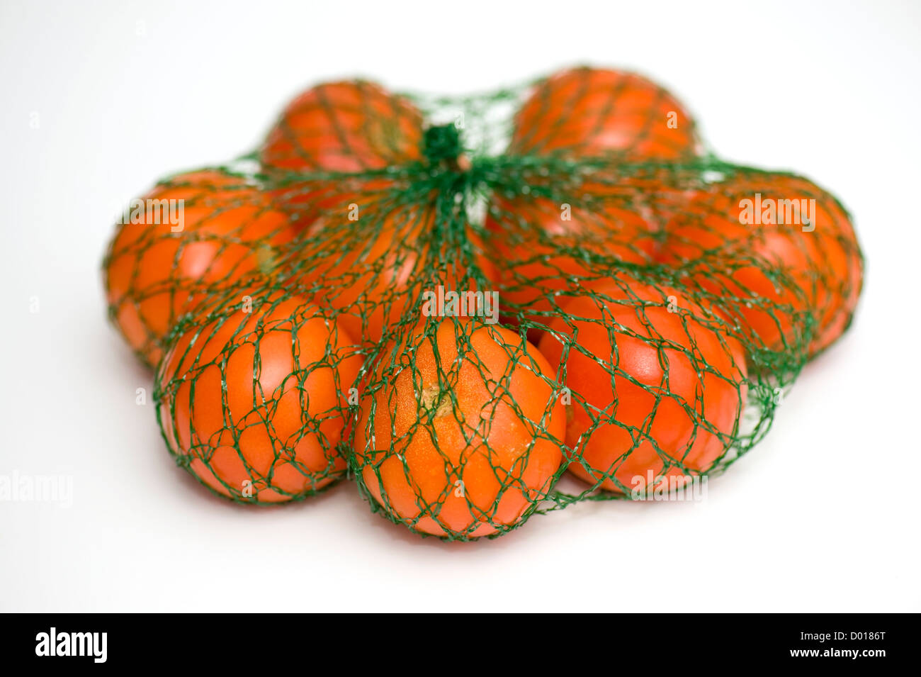 Tomatoes in a netted bag Stock Photo