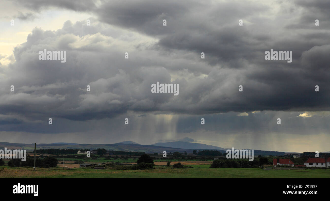 Stormy skies over the Cheviot Hills seen from Seahouses in Northumberland. Stock Photo