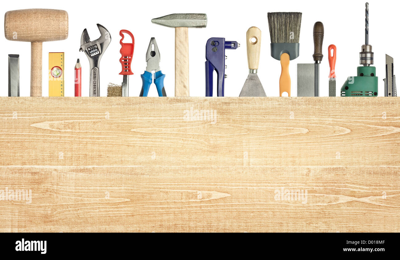 Carpentry, construction background. Tools underneath the wood plank. Stock Photo