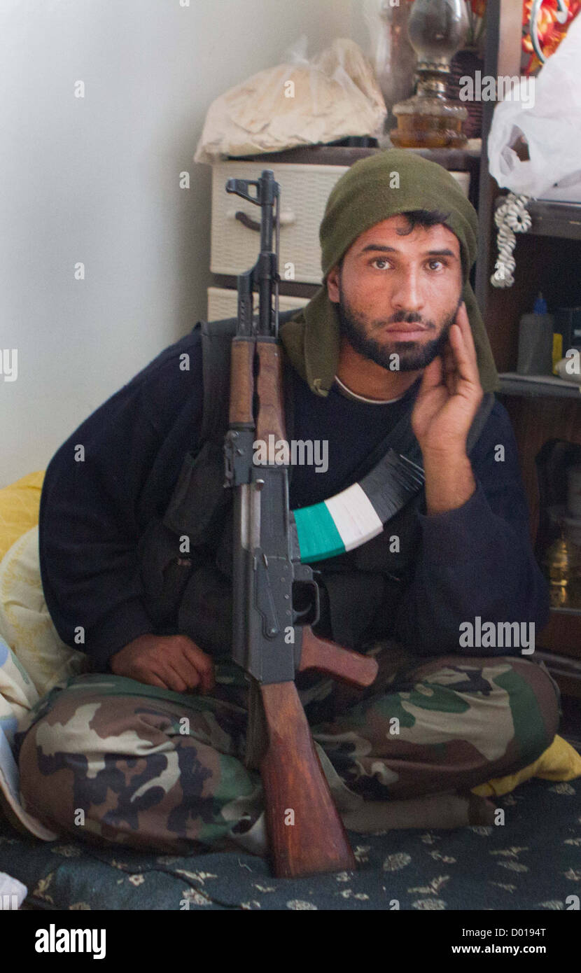 November 2, 2012 - Aleppo, Syria: A Free Syrian Army fighter sits in a safe house near the frontline in Karm Al Jabal. Stock Photo
