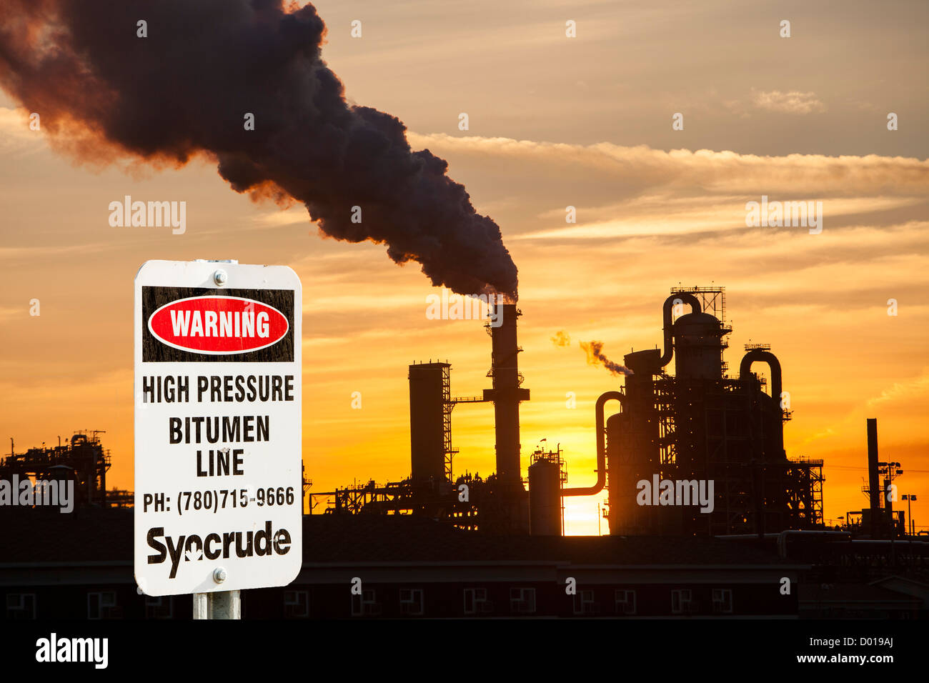 The tar sands upgrader plant at the Syncrude mine north of Fort McMurray, Alberta, Canada, at sunset.. Stock Photo