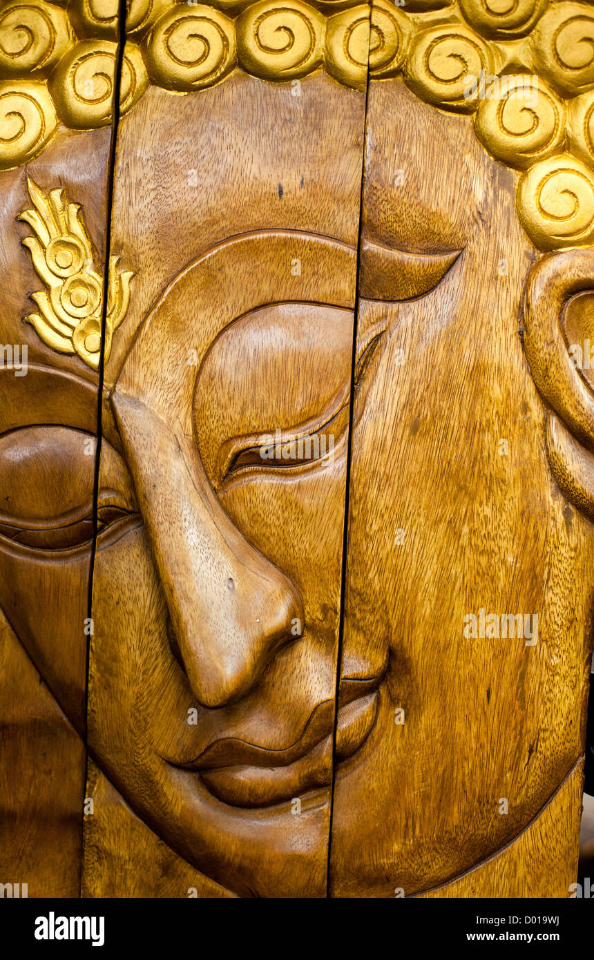 Buddha face as a wooden carving Stock Photo