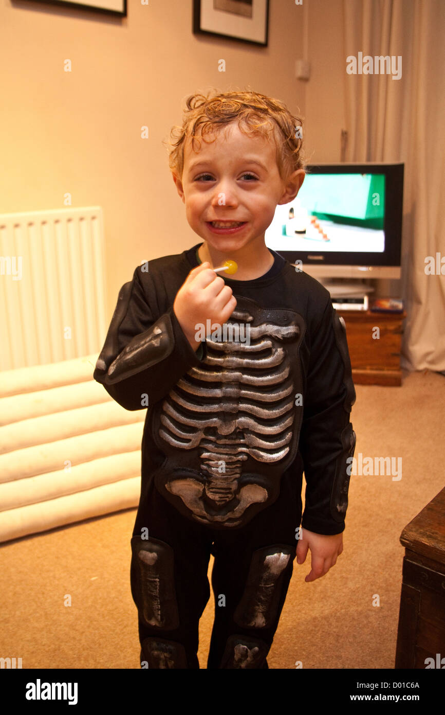 Three year old boy dressed in Halloween fancy dress as a Skeleton