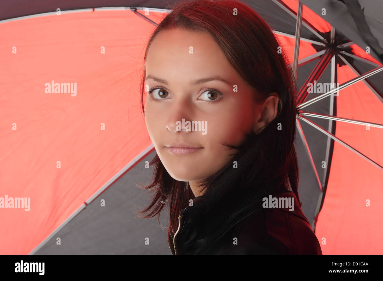 Woman dressed in black under red and black umbrella Stock Photo Alamy