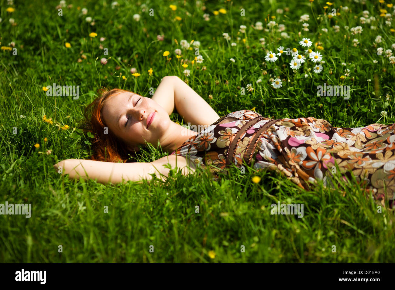 Young woman lying in grass dreaming summer day Stock Photo - Alamy