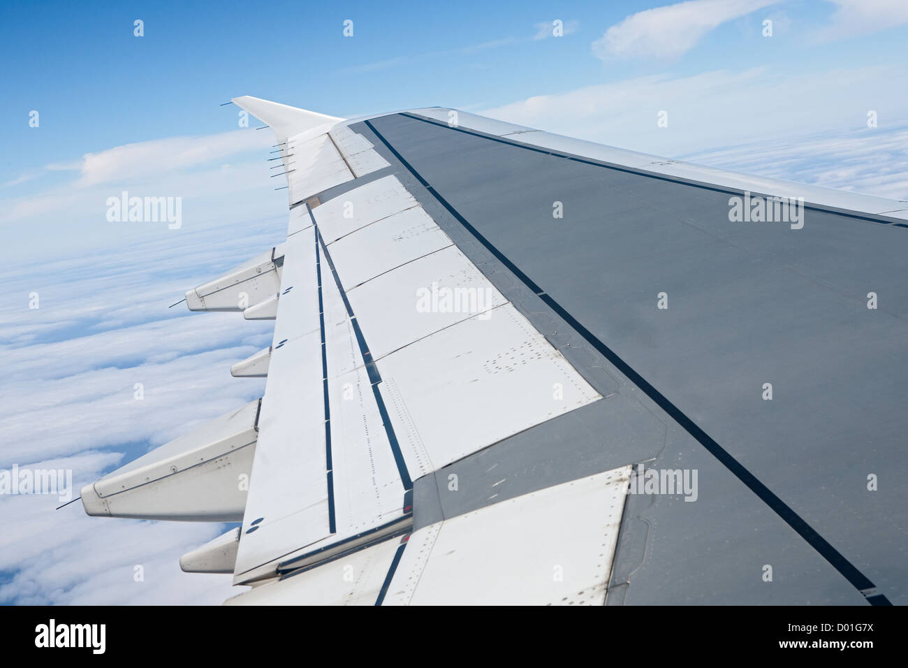 Airplane wing in the blue sky with white clouds Stock Photo - Alamy
