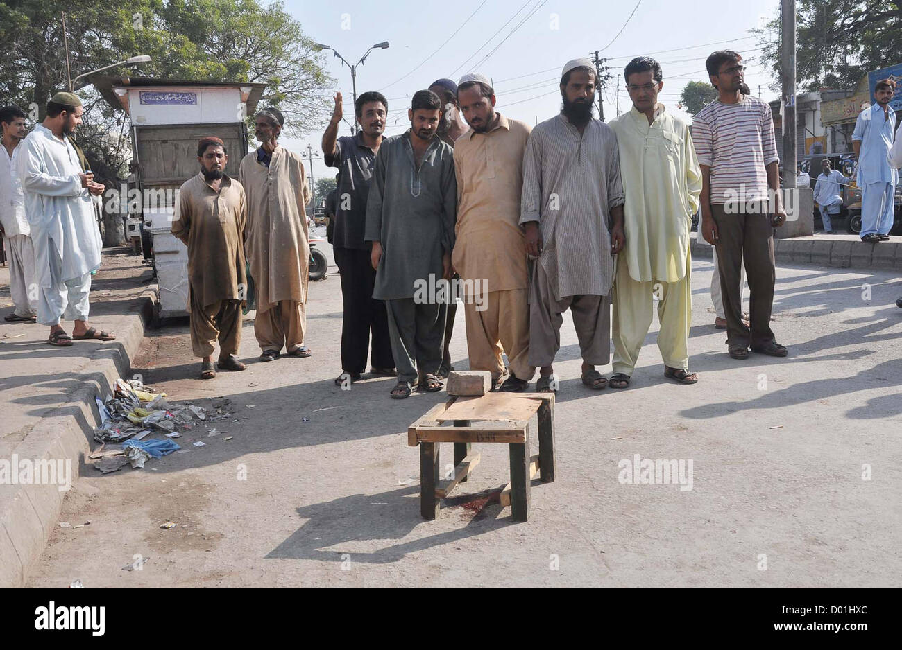 People gather at site after target killing of Ahle Sunnat Wal  Jamat (Defunct Sipah-e-Sahaba), Qari Imran who killed by unidentified gunmen in Jahangir  Quarter area in Karachi on Wednesday, November 14, 2012. As target killings do not seem to  spare the citizens, five persons lost their lives in the on-going spate of violence in the financial  hub today. Stock Photo