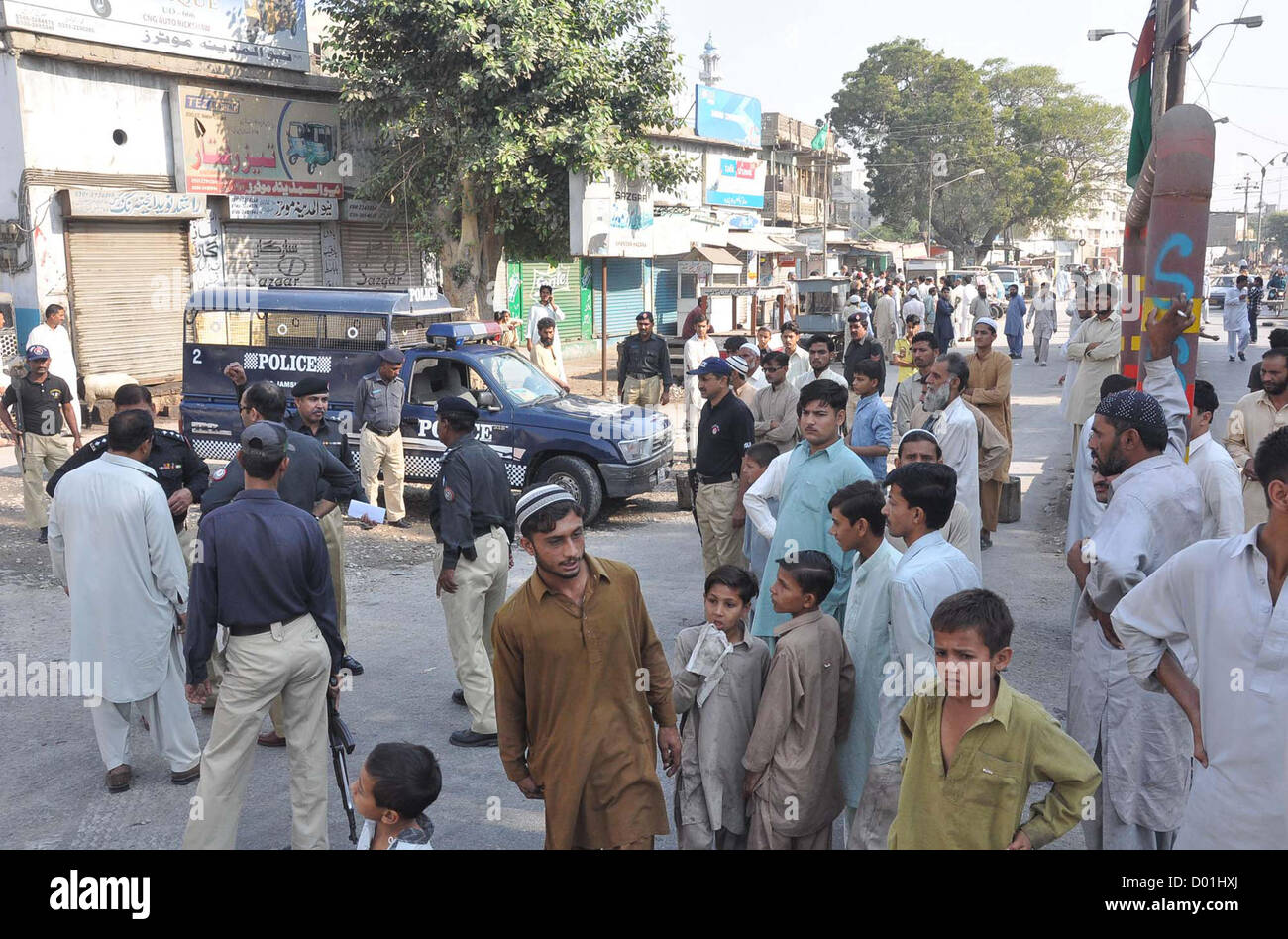 People and Police officials gather at site after target killing  of Ahle Sunnat Wal Jamat (Defunct Sipah-e-Sahaba), Qari Imran who killed by unidentified  gunmen in Jahangir Quarter area in Karachi on Wednesday, November 14, 2012. As target  killings do not seem to spare the citizens, five persons lost their lives in the on-going spate of  violence in the financial hub today. Stock Photo