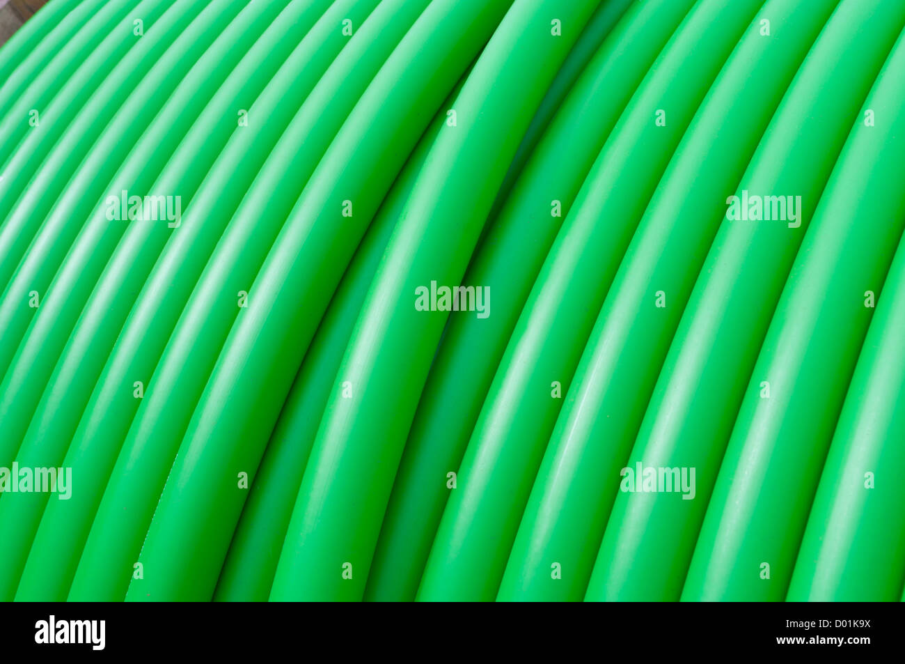 cable drum with green cable on it Stock Photo