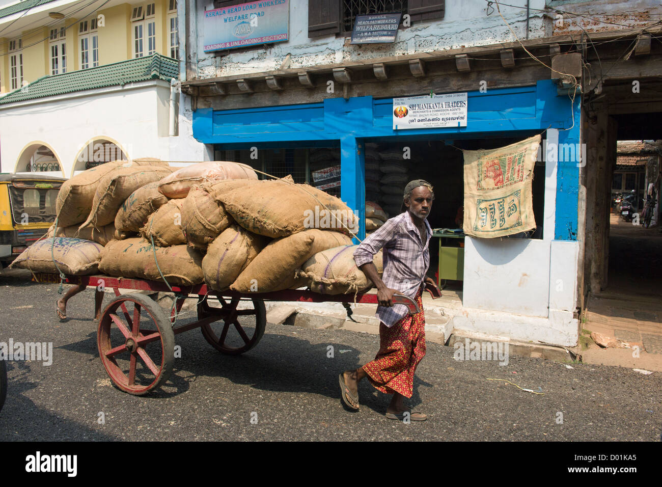 Man pulling a handcart loaded with jute sacks, Bazaar Road, Fort Cochin