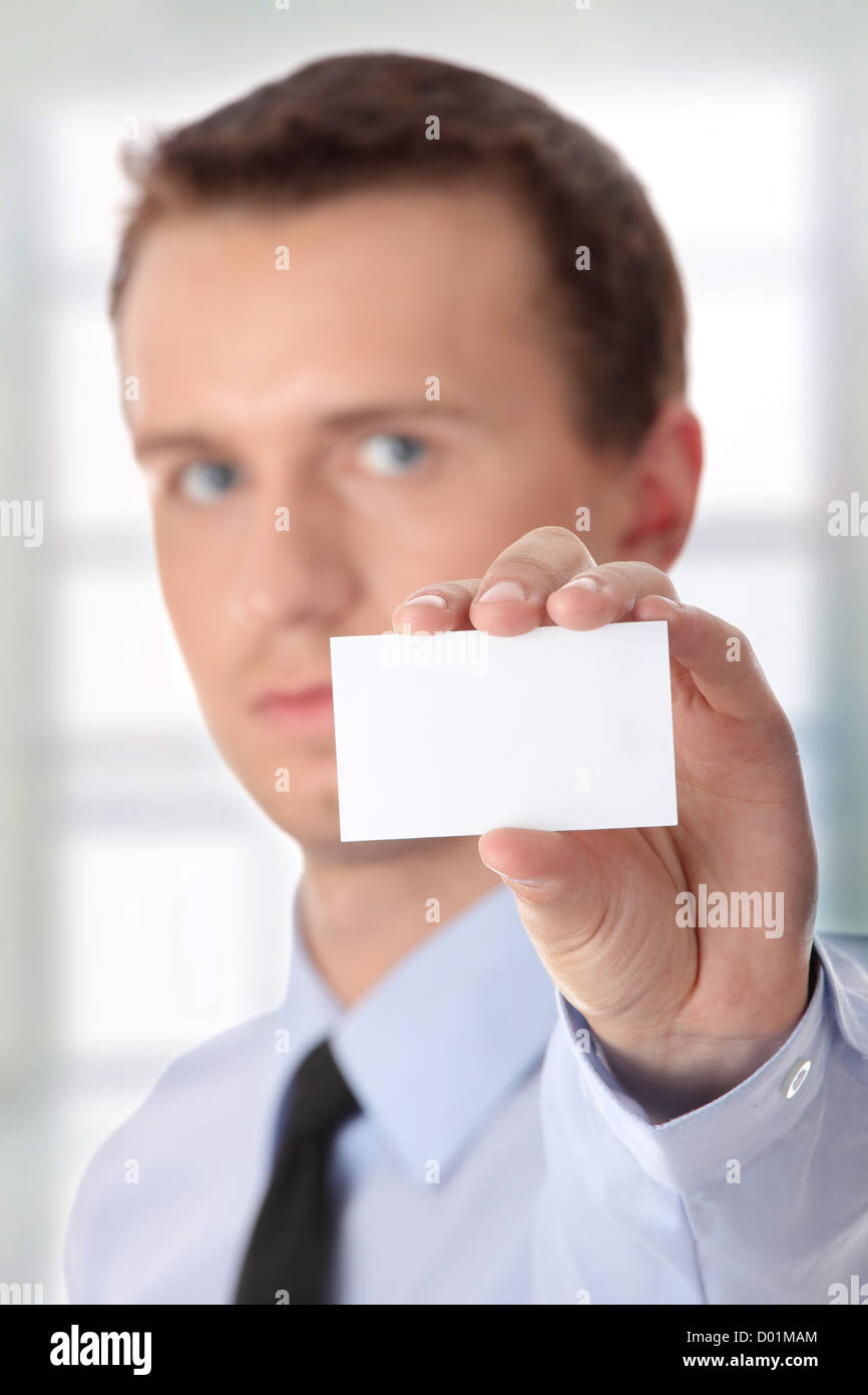 Young businessman holding blank card Stock Photo - Alamy