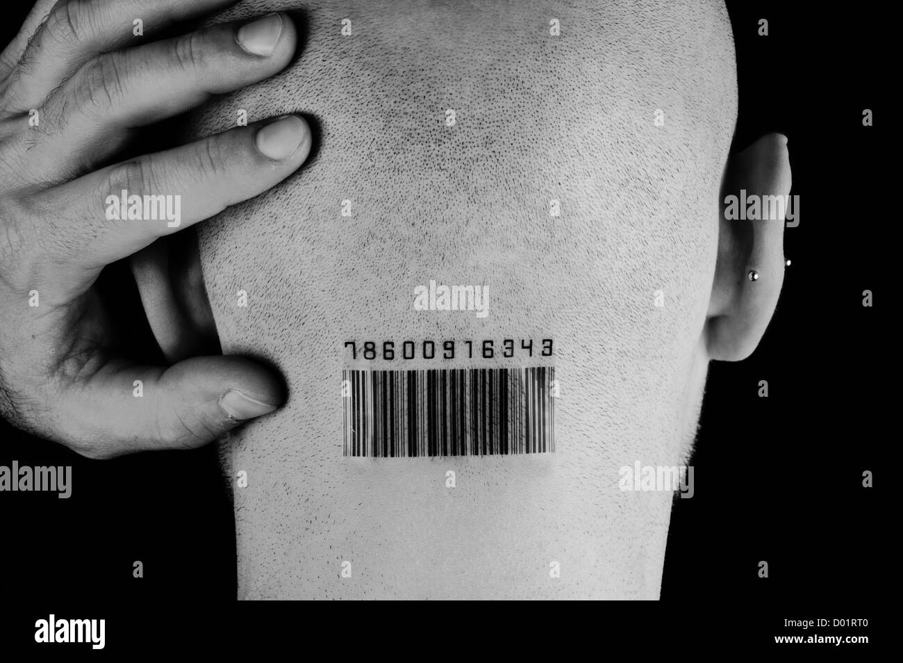 Man with bar code on head against black background Stock Photo