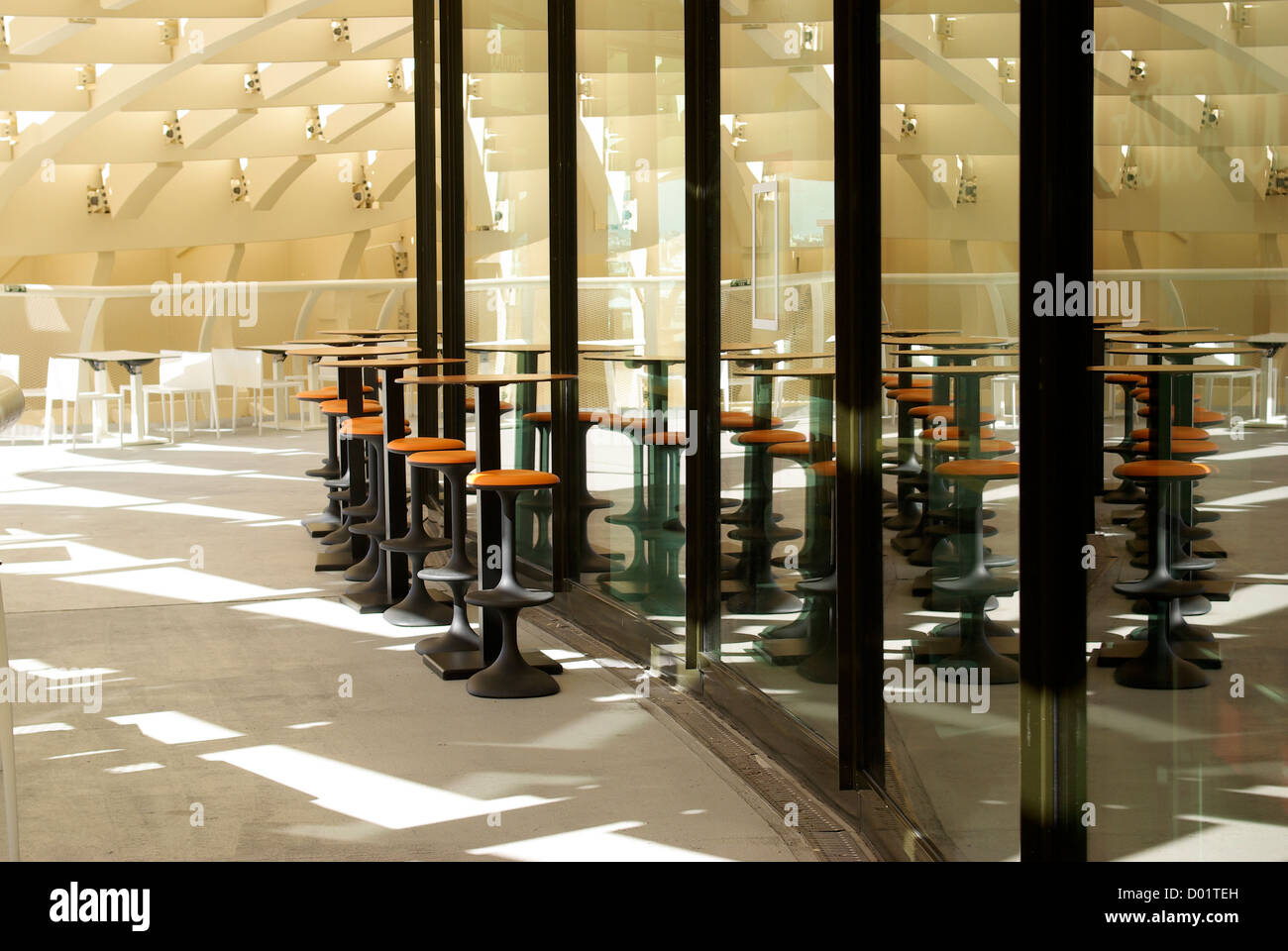 Restaurant stools and chairs reflected in windows on the viewing deck of the Metropol Parasol in Seville, Andalusia, Spain Stock Photo