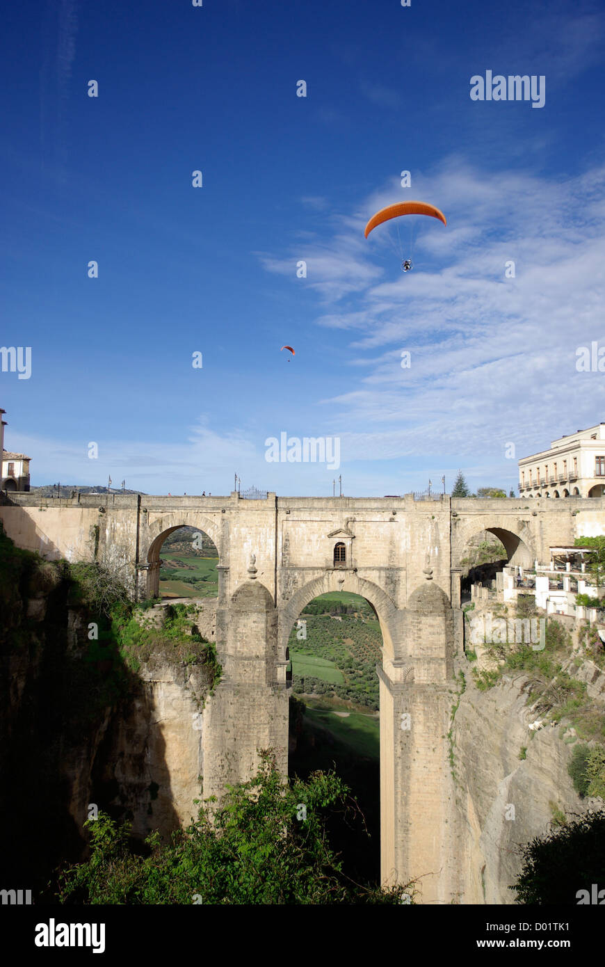 Powered parachutes / paragliders flying over the Puente Nuevo bridge in Ronda, Andalusia, Spain Stock Photo