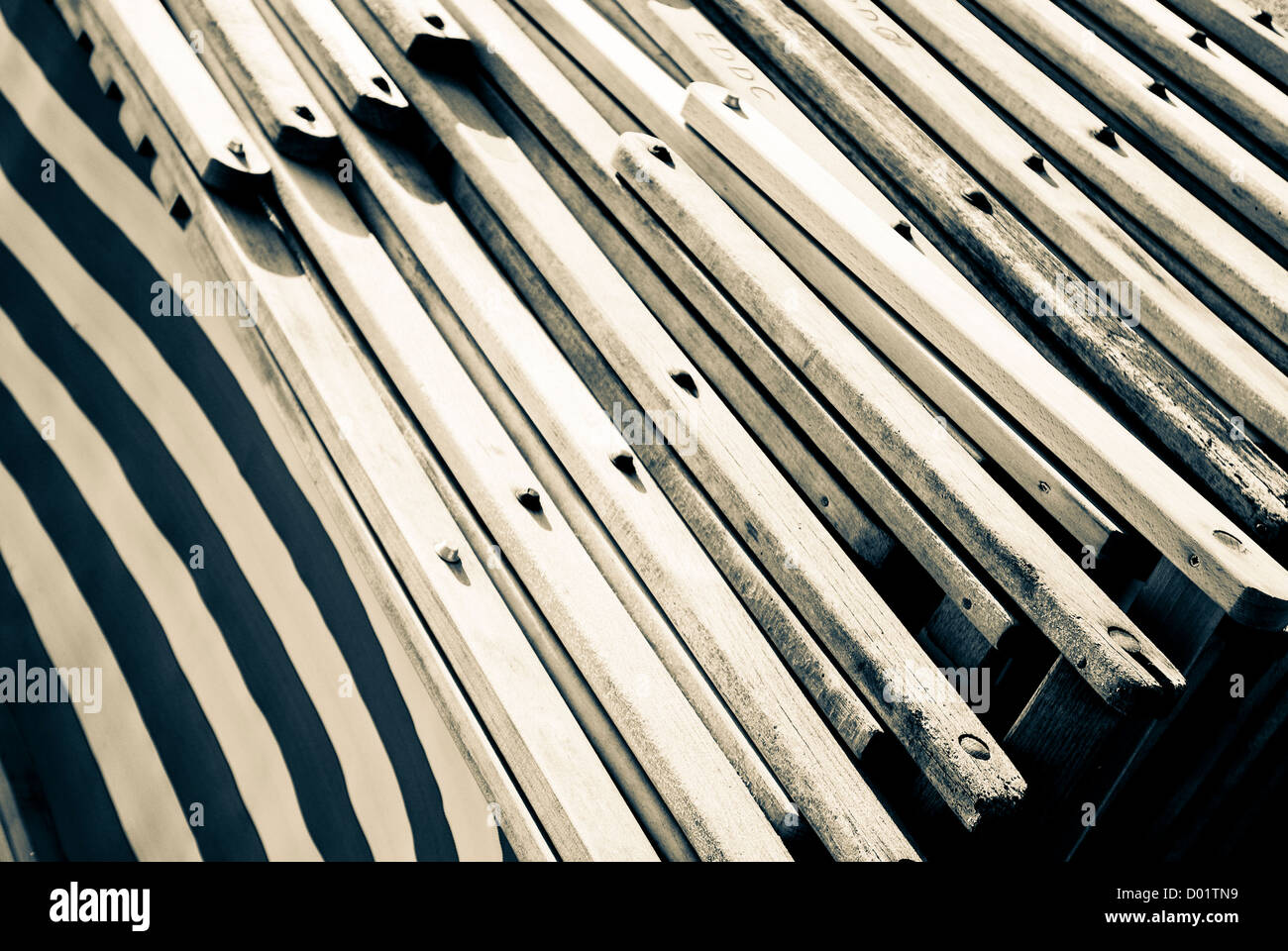 Stack of wooden deckchairs, desaturated effect Stock Photo