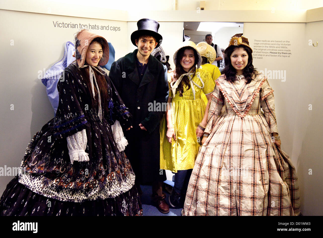 Tourists trying on victorian costumes in the Fashion Museum, Bath Somerset UK Stock Photo