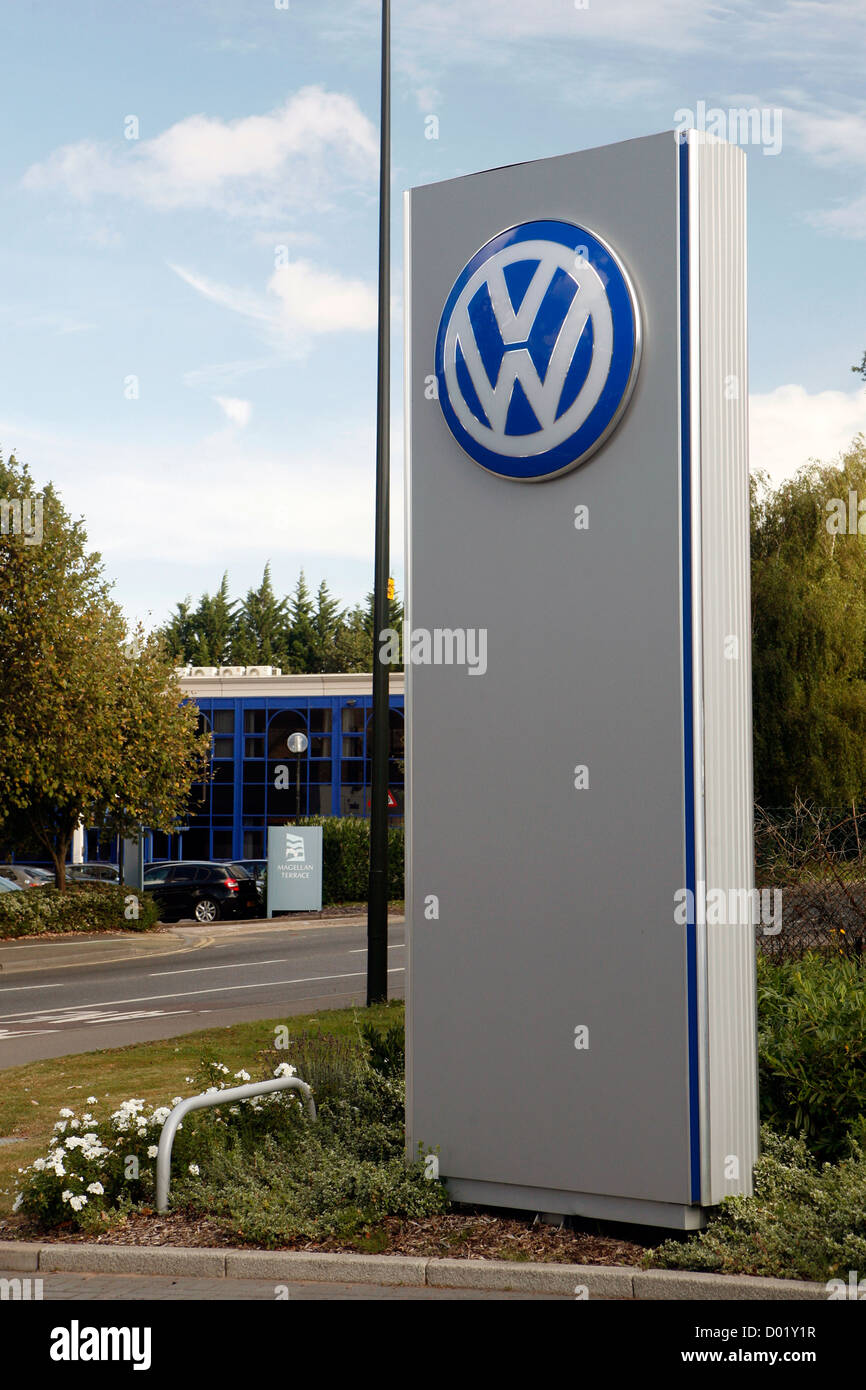 A large Volkswagen logo on display outside a VW car dealership in the UK. Stock Photo