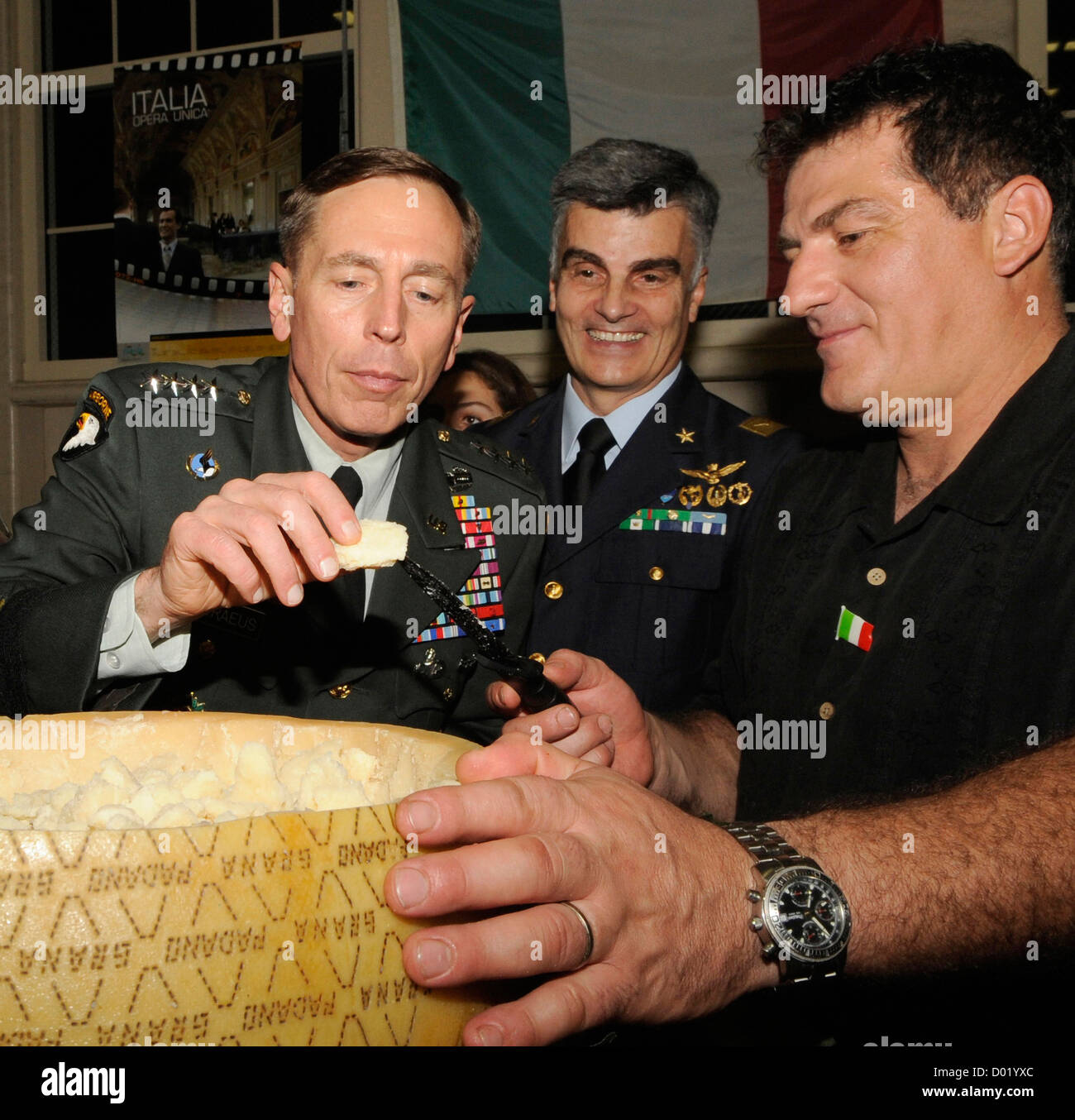 US Army General David Petraeus samples a piece of the Parmigiano-Reggiano cheese during International Night December 16, 2008 at MacDill AFB, FL. Petraeus resigned as Director of the CIA on November 9, 2012 after issuing a statement saying that he had engaged in an extramarital affair. Stock Photo