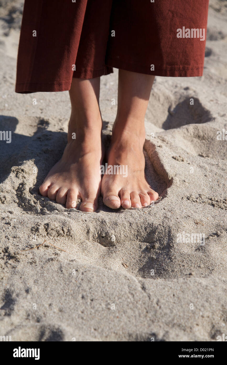 woman feet barefoot on beach sand Stock Photo