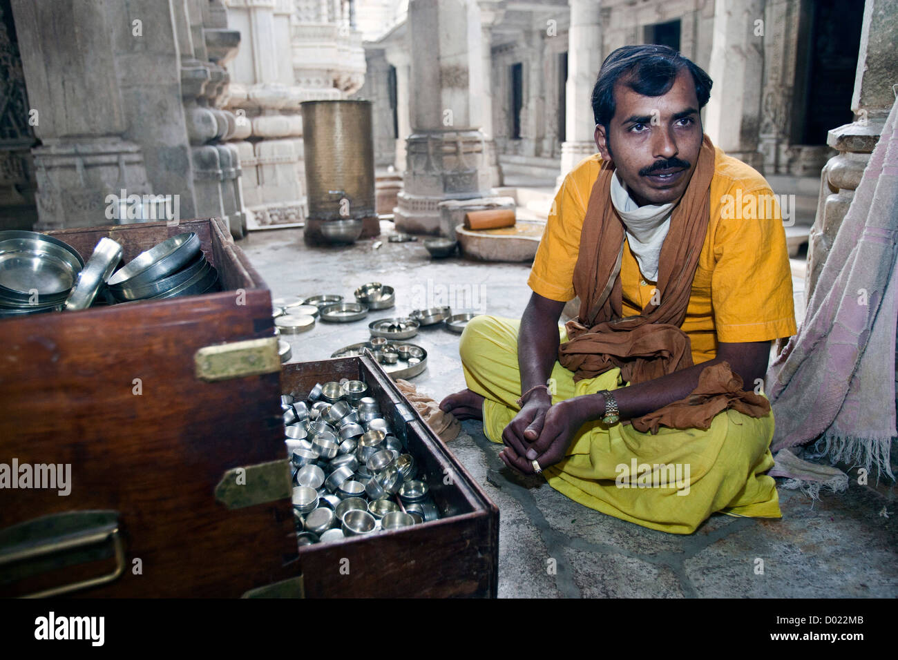 Priest in saffron robes Jain Temple Ranakpur Rajasthan India Stock Photo