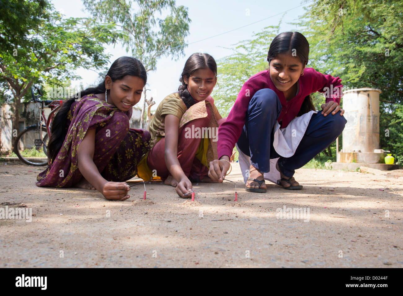 Indian teenage girls lighting firecrackers at Diwali festival. Andhra Pradesh, India Stock Photo