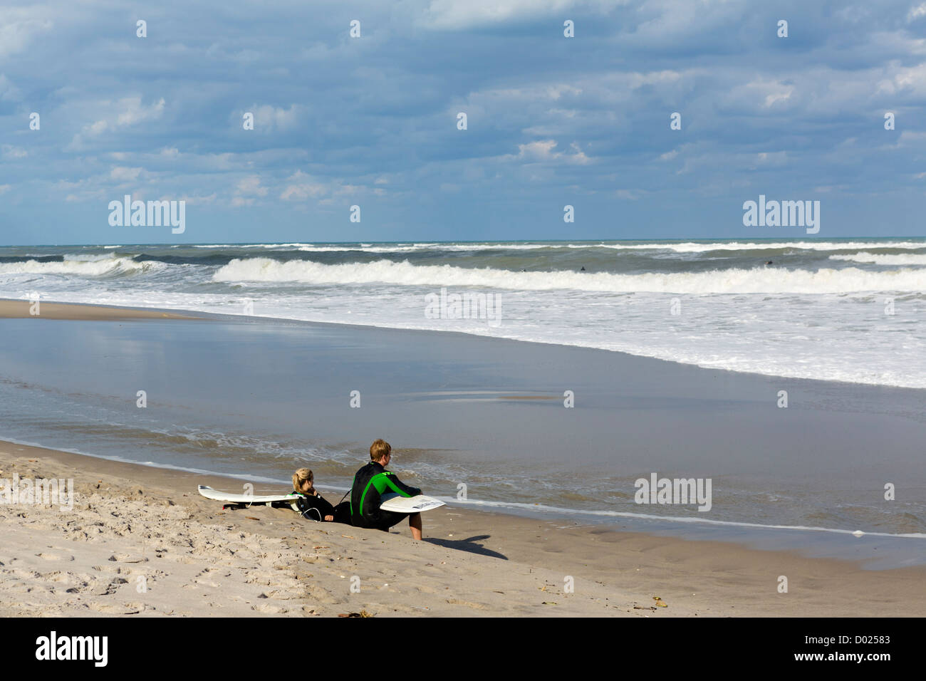 Young surfers resting on the beach in Jupiter, Palm Beach County, Treasure Coast, Florida, USA Stock Photo