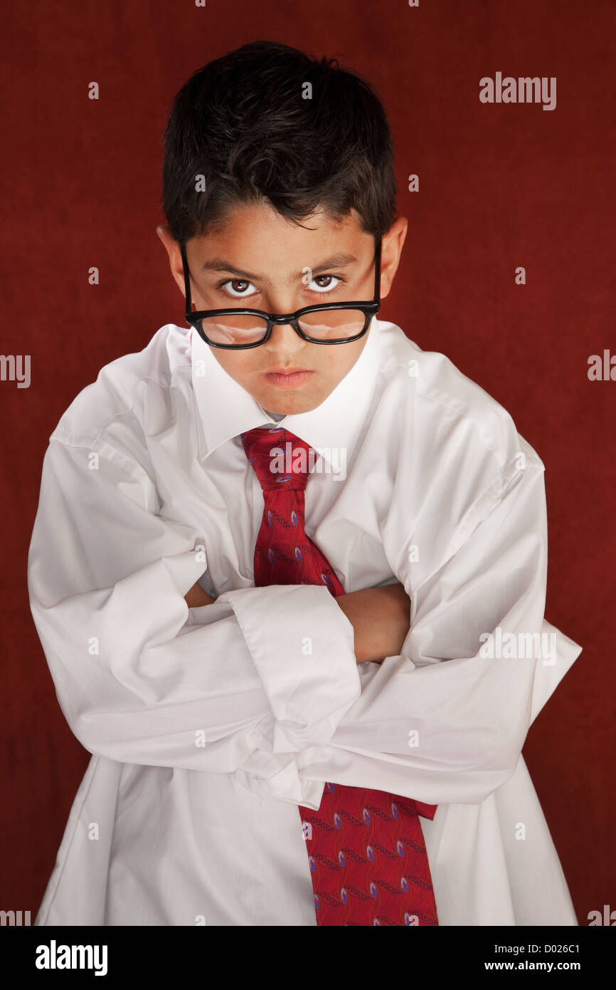 Cute young boy in his father's shirt and eyeglasses Stock Photo