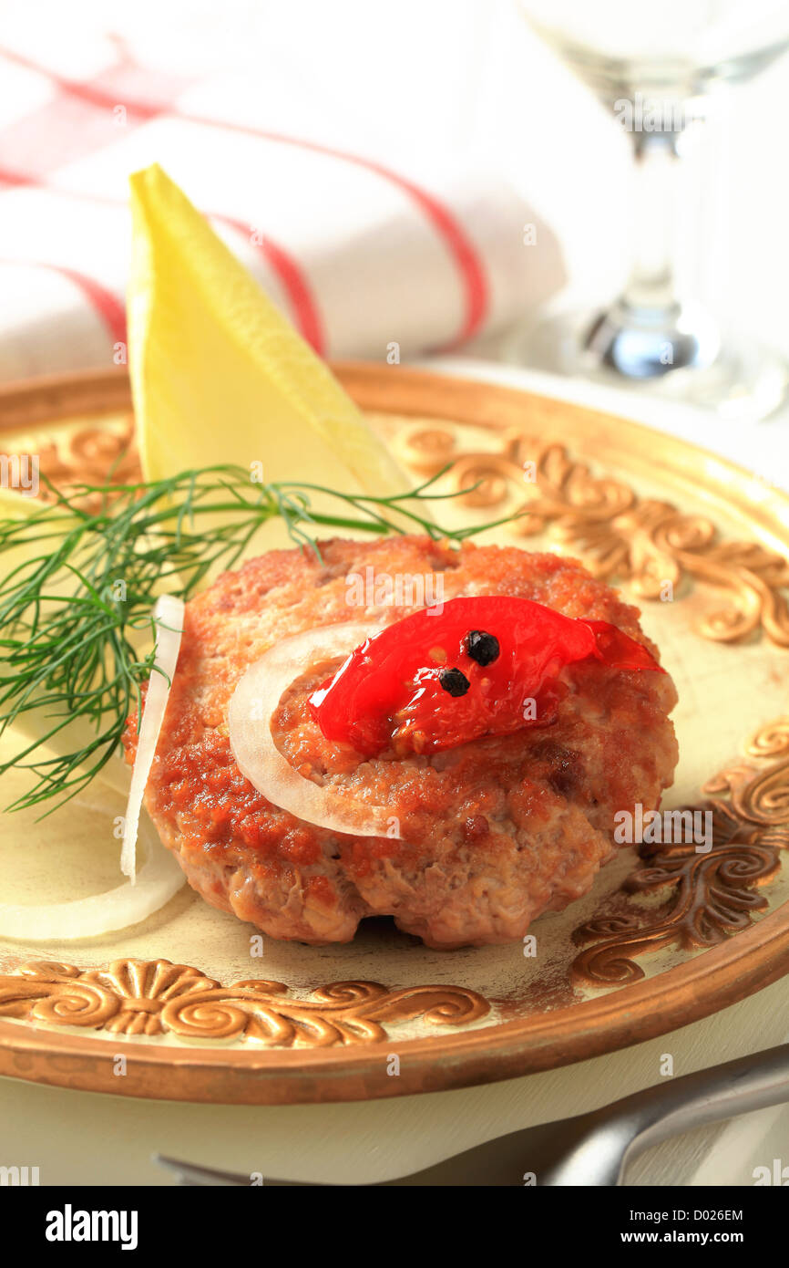 Pan fried burger garnished with endive leaves Stock Photo Alamy