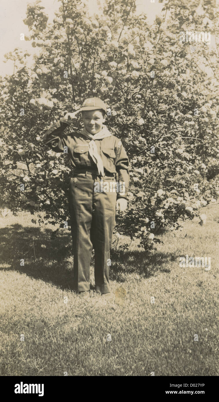 Circa 1930s photograph, Boy Scout giving a salute, probably Massachusetts, New England, USA. Stock Photo