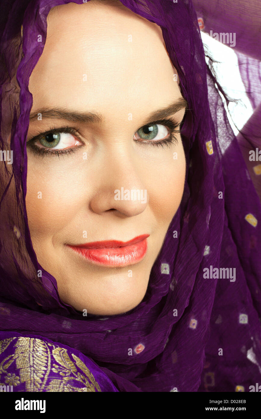 Closeup portrait of a beautiful Indian woman wearing a head scarf and looking at the camera Stock Photo