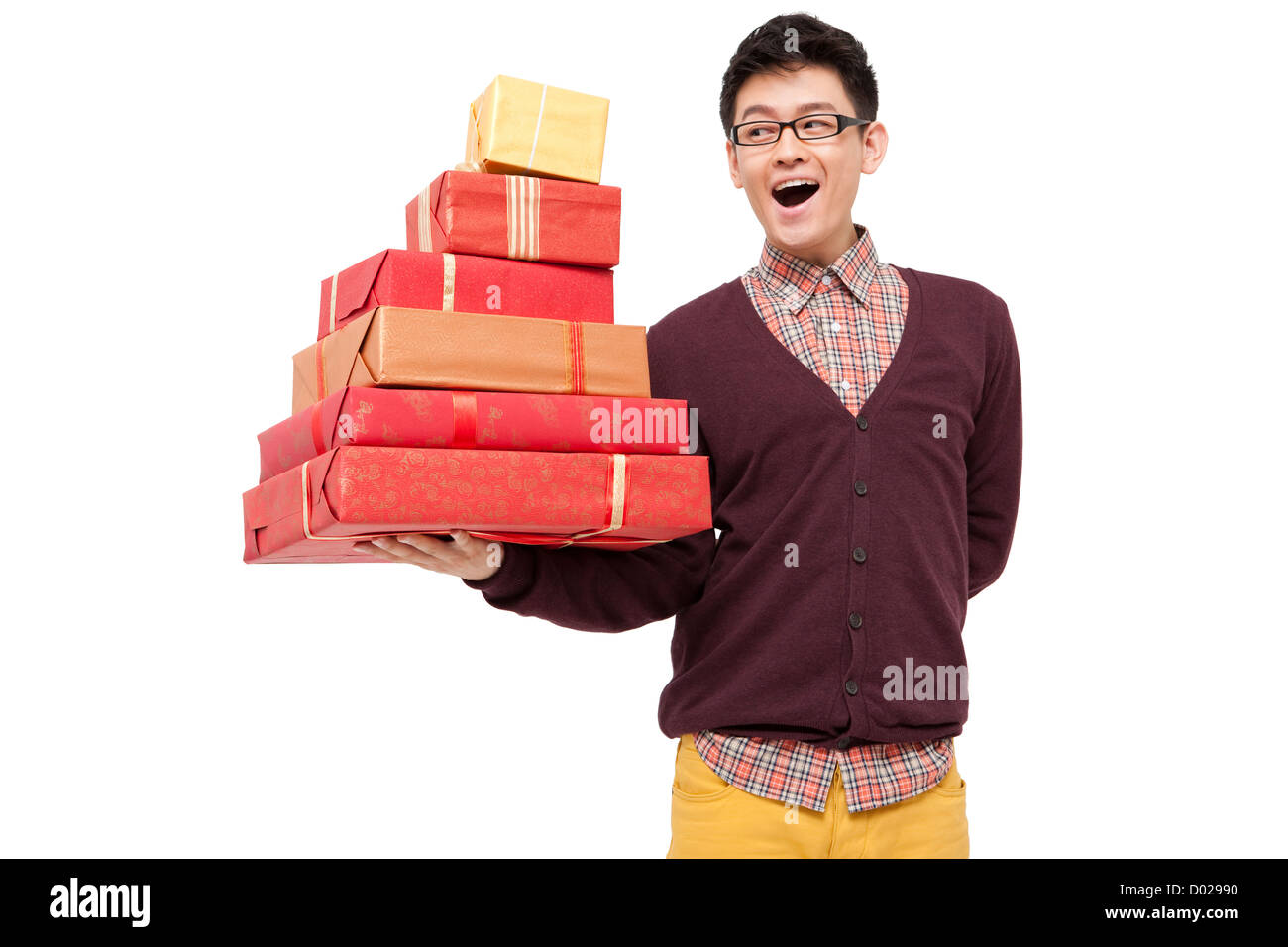 Humorous young man holding gift for Chinese traditional New Year Stock Photo