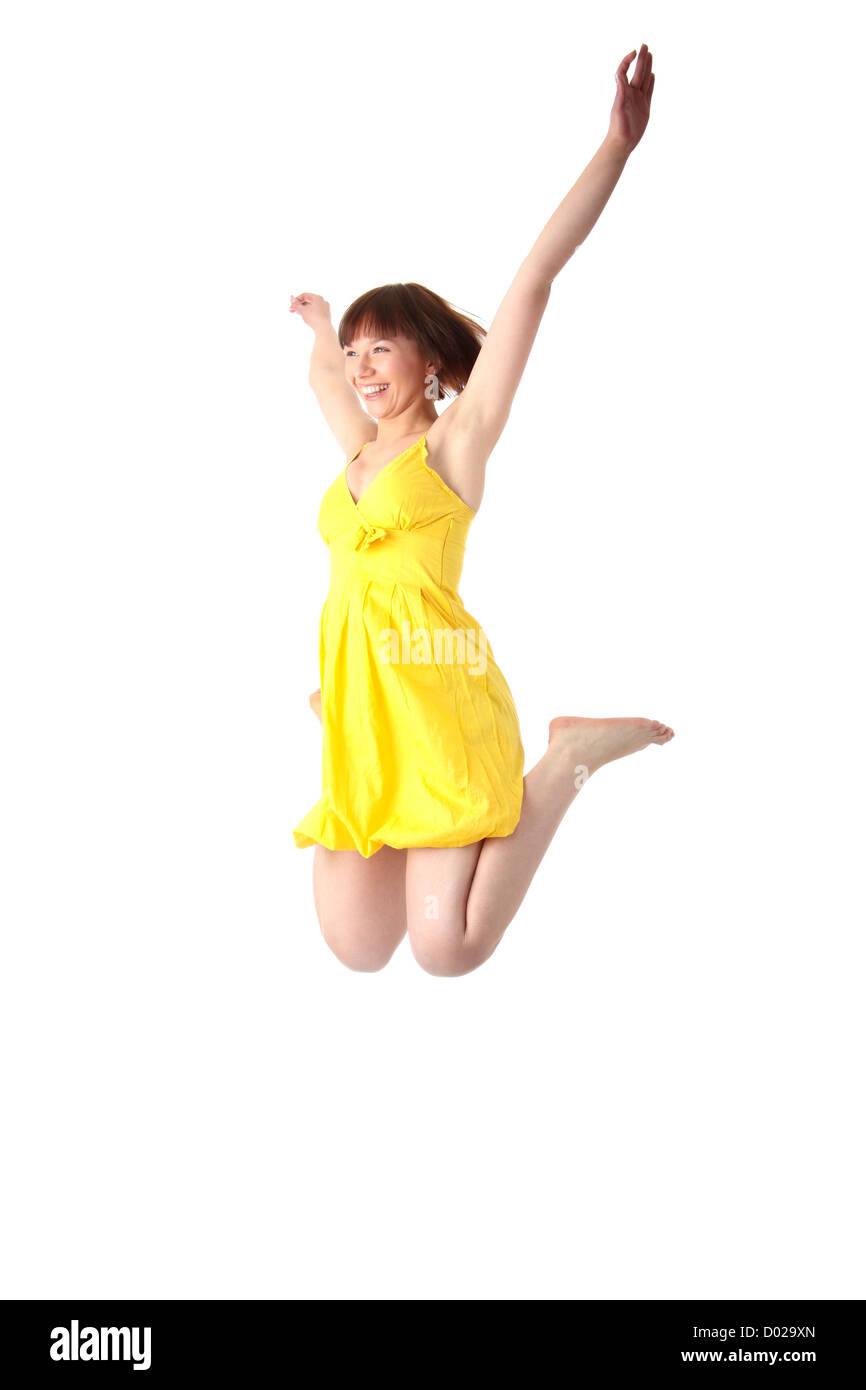 Young smiling teen girl in yellow summer dress jumping. Isolated on ...