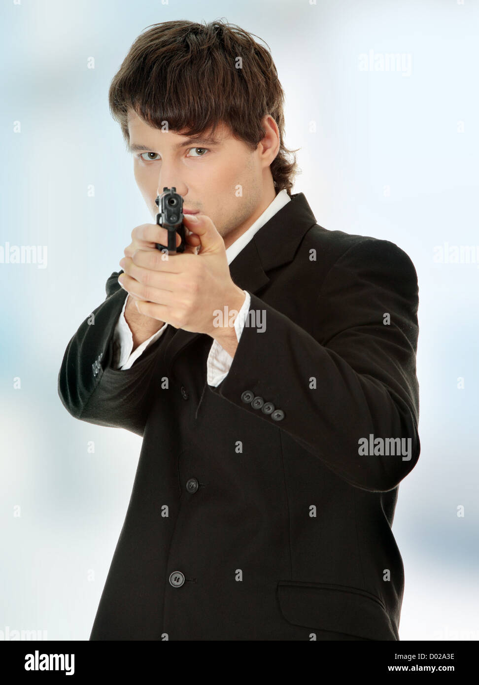 Businessman aiming with handgun Stock Photo Alamy