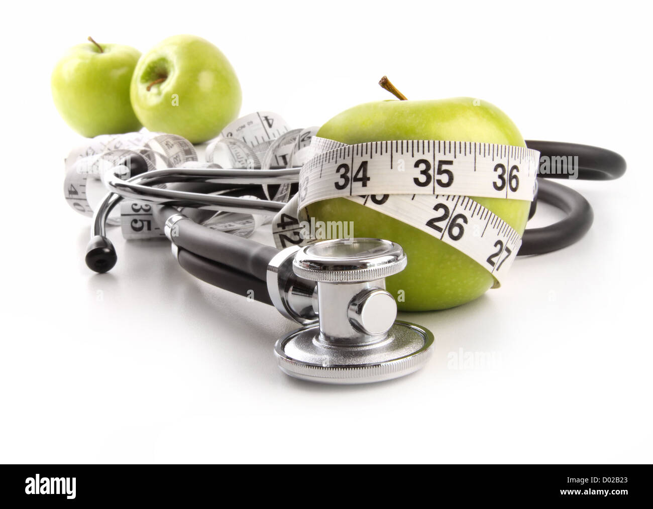 Green apples with stethoscope against white background Stock Photo Alamy