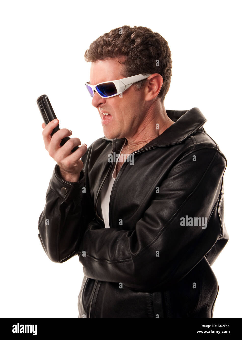 Man in leather jacket looks at his cell phone in disgust Stock Photo ...
