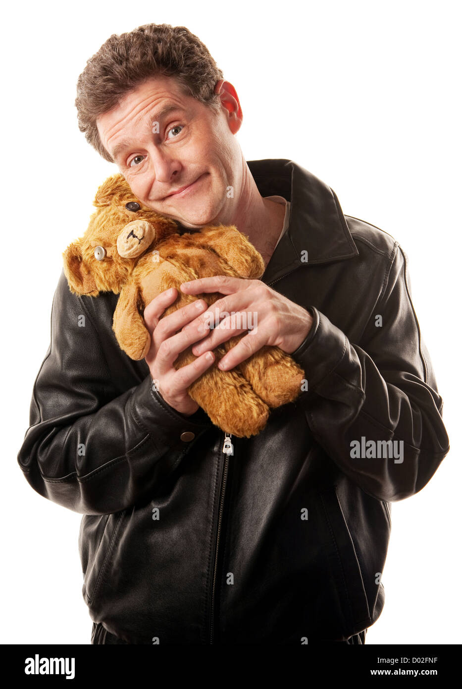 Man in leather jacket clasps teddy bear Stock Photo