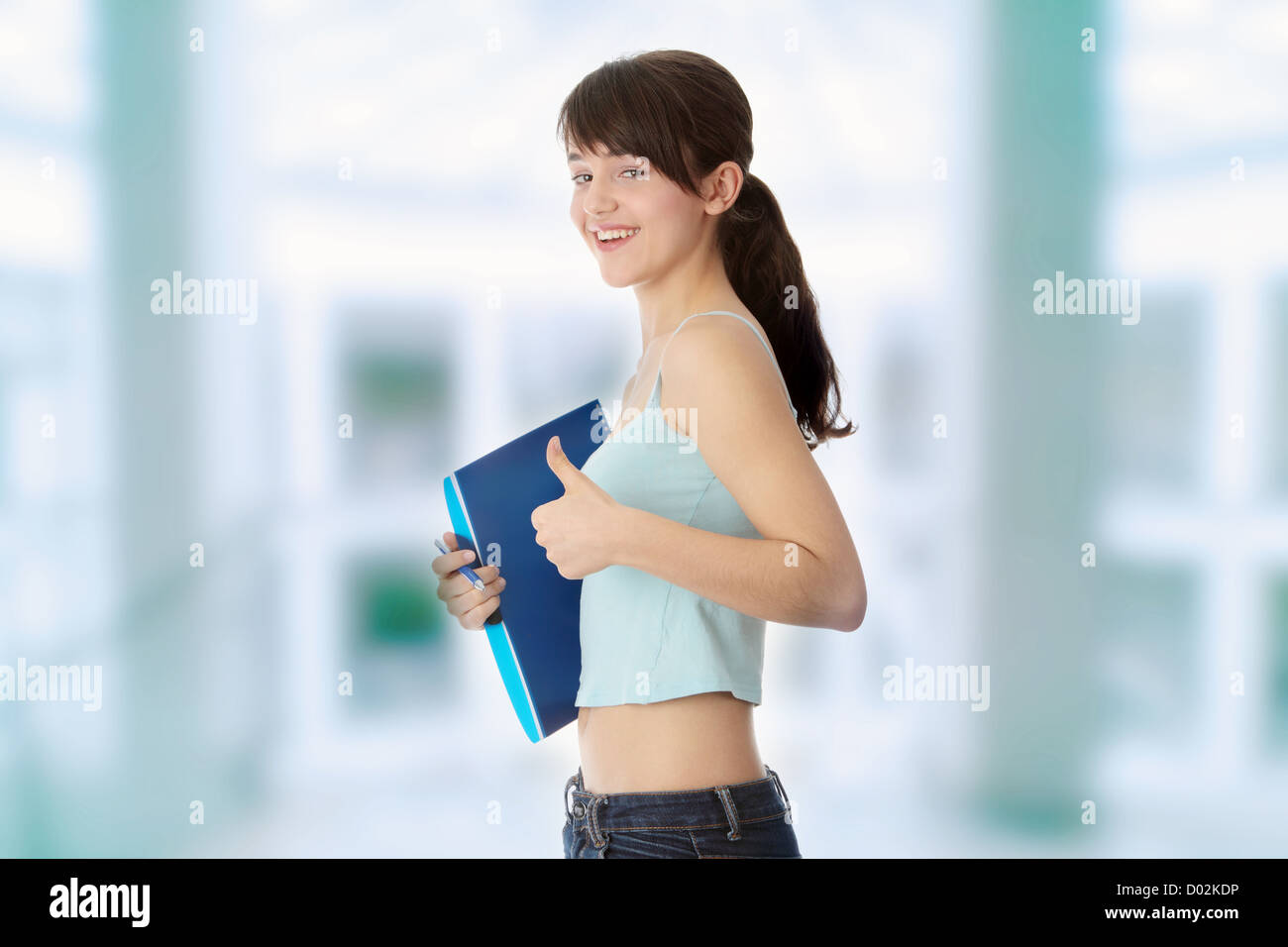 Young student girl with thumb up isolated on white background Stock ...