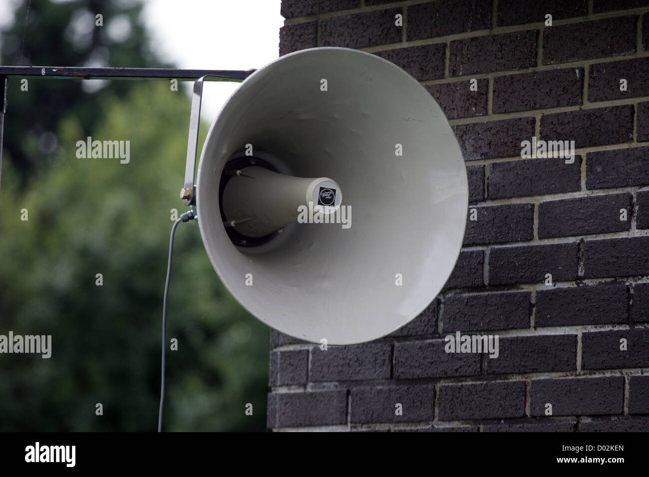 A large megaphone speaker tannoy PA system attached to the outside