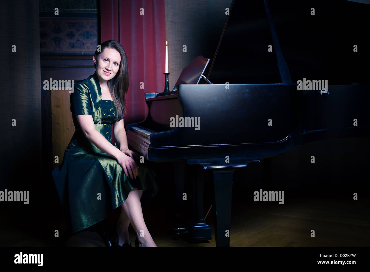 indoor portrait of a young female piano player Stock Photo