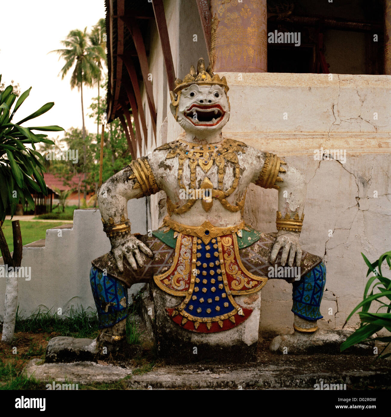 Demonic sculpture standing guard outside Buddhist temple Wat Aham in Luang Prabang in Laos in Indochina in Far East Southeast Asia. Demon Travel Stock Photo