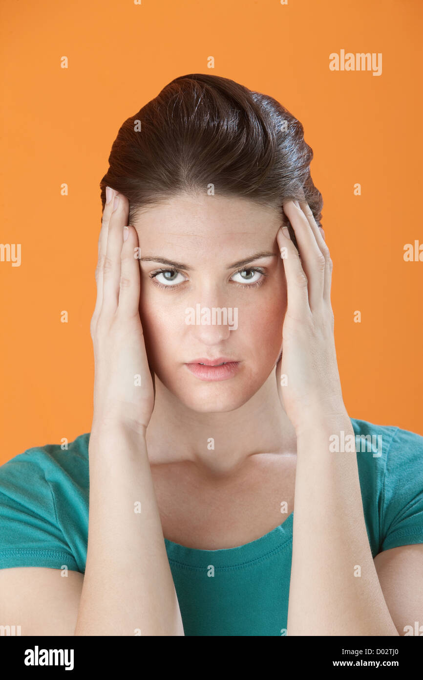 Stressed out Caucasian woman massaging her temples with fingers Stock ...